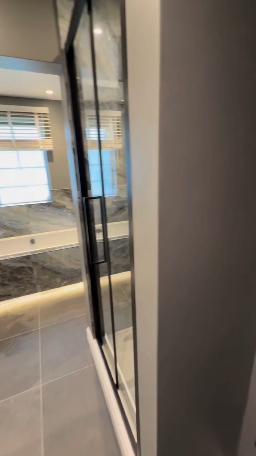 Family bathroom transformation from an awkward narrow space into a relaxing bath and shower room