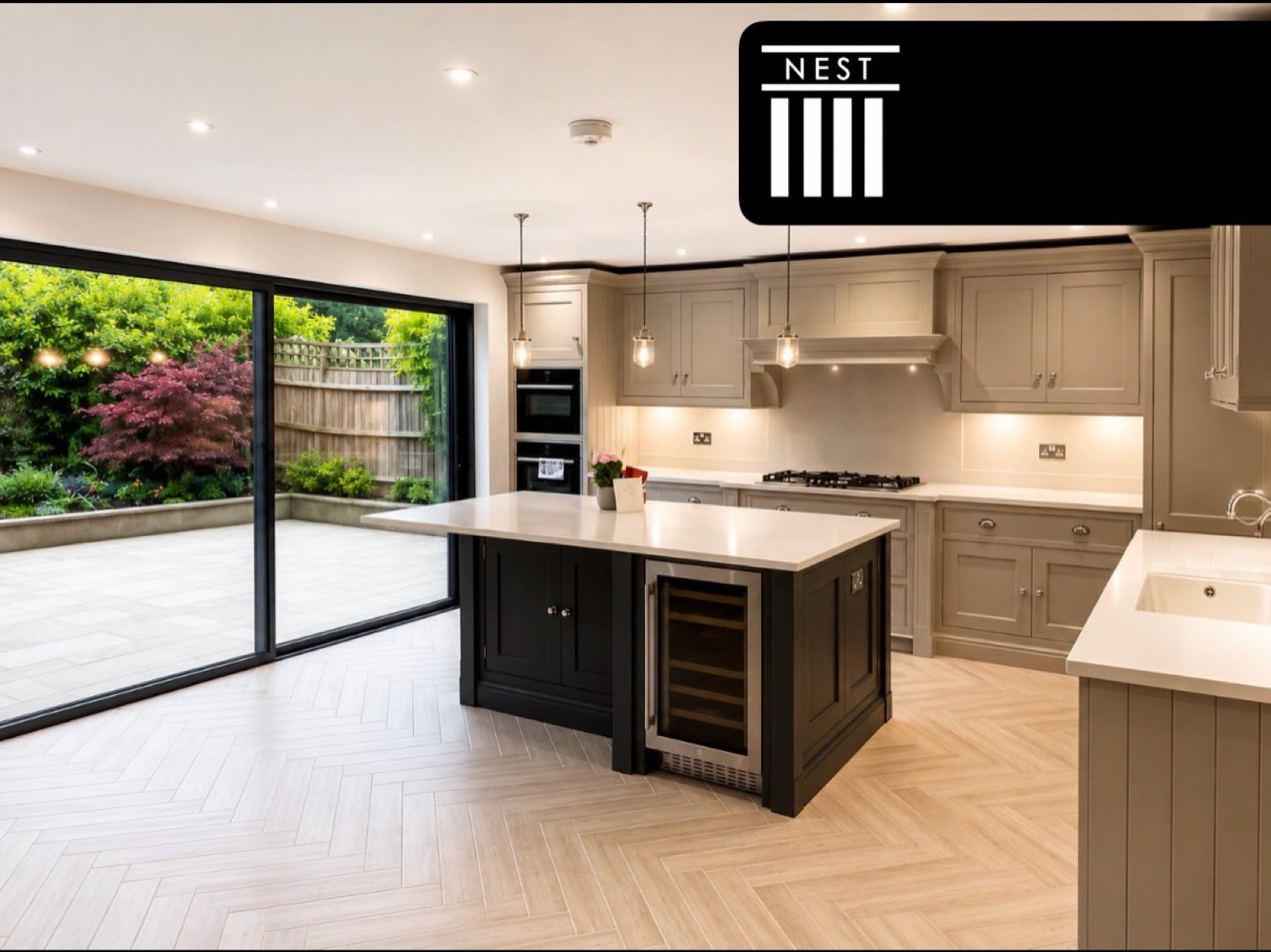 Contemporary kitchen renovation with quartz worktops and contrasting island by Nest Building Group